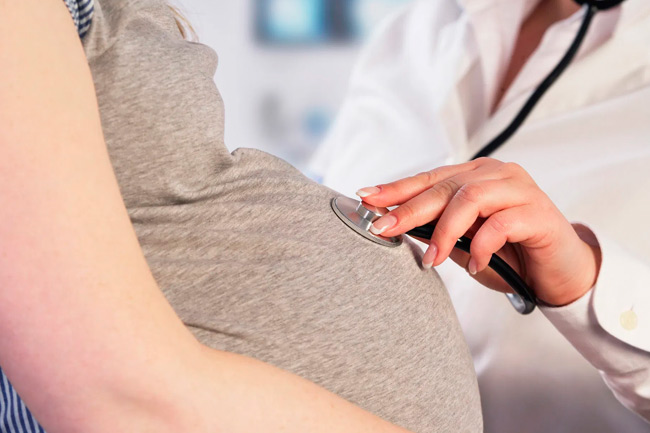 Enfermera revisando mujer en embarazo